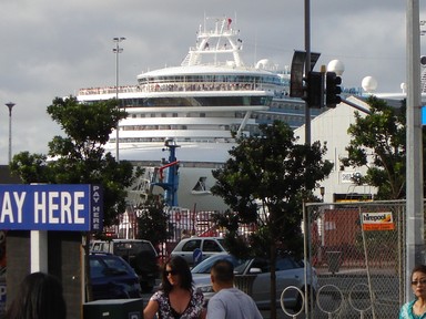 Samantha Smith; Cruising Around; Lots of passengers line the top deck of this cruise ship as it leaves Port