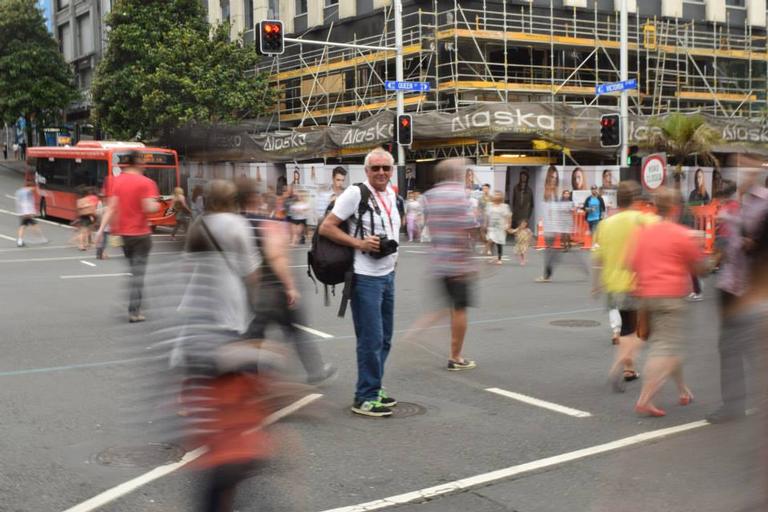Deepti Bhargava;Still motion ;A photographer stands still in the middle of the busy Queen street crossing in Auckland city.