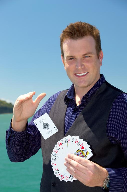 Auckland magician Mick Peck performing magic tricks at Okahu Bay
