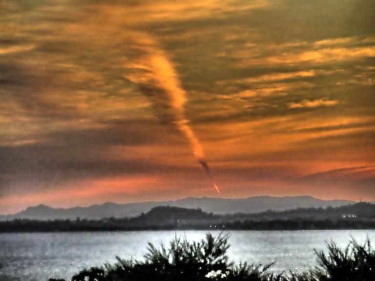 Joan Kirk; What is it;T aken from Rocky Bay at sunset. Now know it is a jet trail the the sun has caught.