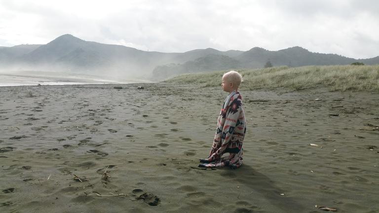Georgia Wilson;Bundled;Piha beach wrapped up warm after falling in the estuary