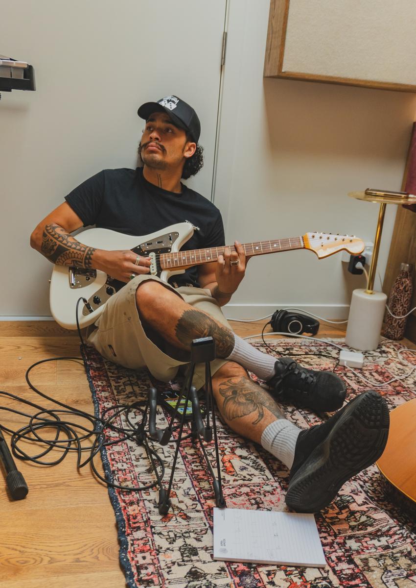 Shelley Te Haara; Reiki in Studio; I was documenting APRA SONGHUBS and was asked to document many musicians in studio sessions throughout the week. Something about Reiki just sitting on the ground with a guitar, squashed in to this studio really caught my attention