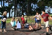 Bernie Harfleet; multi ethnic meeting place;Children of some of the many cultures that make up Auckland meet on the round about at Pt Chev park
