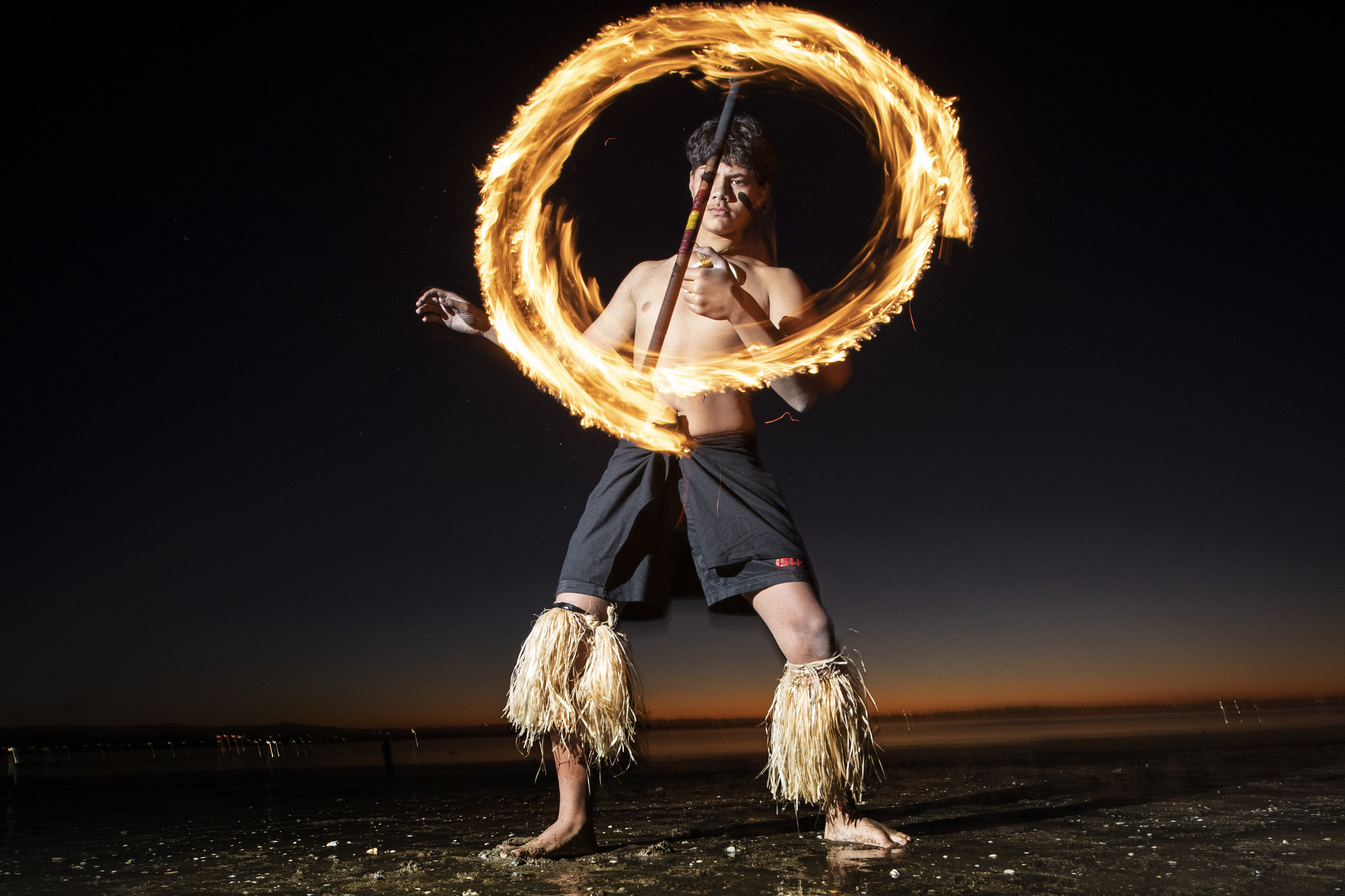 Tahi Mana member DJ Papalii performs Siva Afi or the Samoan Fire knife dance at sunset on Point Chevalier Beach by Jason Oxenham - NZ Herald photographer