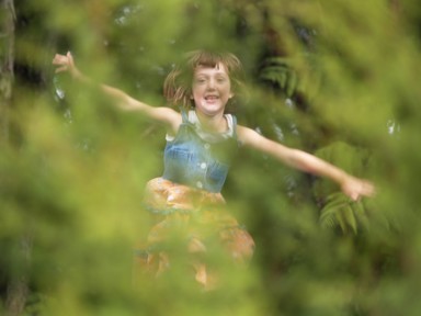 Jolyon Smith; Bouncing In The Bush; Rather than get up and move to snap my daughter bouncing on a trampoline, I decided to play with the depth of field to resolve the subject and throw the foreground bush out of focus, lending a natural softness to a moment of childish delight