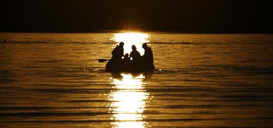 Bojana Stojadinovic; The City of Sails (even without them); Taken at Bucklands Beach looking onto Kohimarama. A family catches the sunset on an inflatable boat.