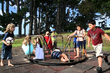 Bernie Harfleet; multi ethnic meeting place;Children of some of the many cultures that make up Auckland meet on the round about at Pt Chev park