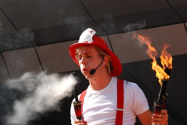 Paras Kumar;Busker;Buskers festival in New Zealand provides an opportunity for buskers from different parts of the world to showcase their talent. Just as I was passing by one of the streets in Auckland I saw this juggler was about to end his show. Here he is seen blowing off one of the torches with which he was performing.