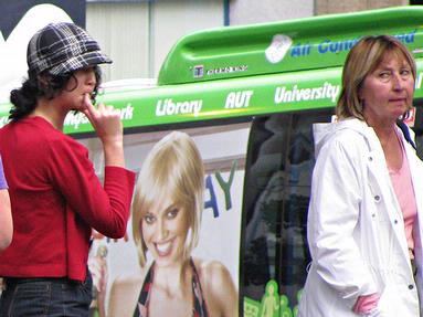 women at busstop in city center