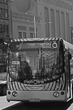 Catrina Sewell; Queen St Reflection; The NZ town signpost markers and buildings further up Queen St are reflected on drivers window