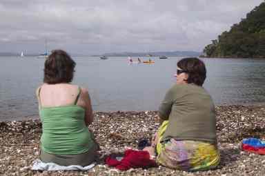 Denis La Touche;Water playground; Mothers watch while their kids enjoy the watery playground at Owhanake Bay, Waiheke Island