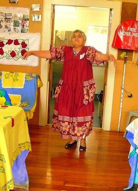 Alwynne Wedgwood; Mama in African Dress; When Otahuhu celebrated the International Day for Older People last year, St Andrews Church put on an exhibition of ethnic crafts. Our South African Minister donated some examples of African embroidery.  Cook Island Mama Ruapuna modelled one of the dresses.