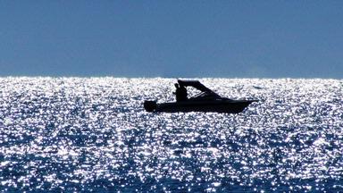 JERRY ZINN; LONE FISHERMAN; IT LOOKED LIKE A SPARKLING SEA OF DIAMONDS