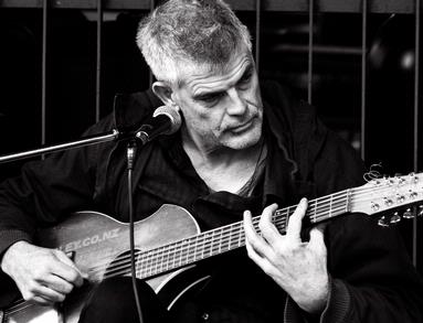 Chrystal Oosthuizen;Strum away the blues; Musician (Luke Hurley) playing on Queen Street in front of Starbucks