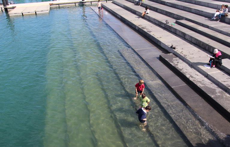 Ren Chinnamunian; Water fun at the new Waterfront; This pic was taken at the new Auckland Waterfront. While waiting for the suspension bridge to open I spotted these kids playing.  It's a great contrast to the relaxing adults sitting around them on the steps.