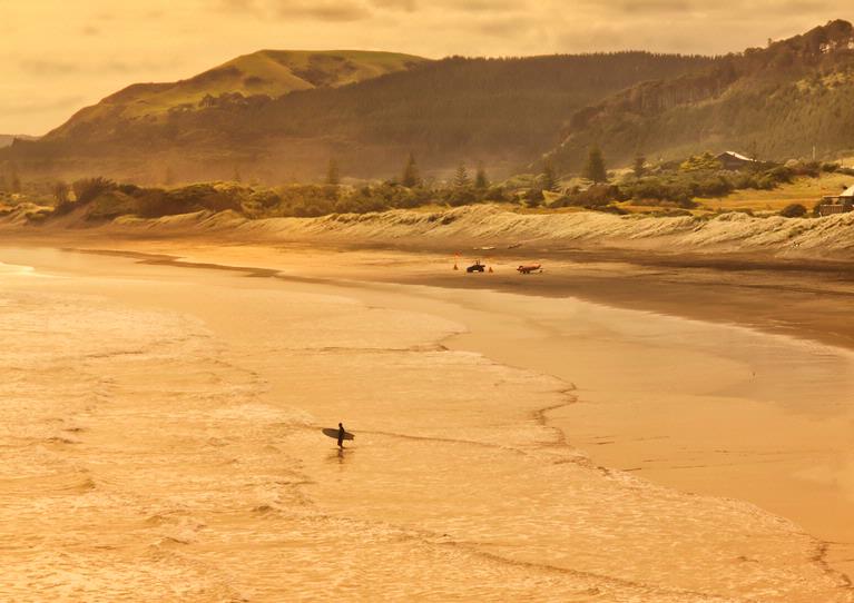 Susan Blick; Silhouetted Surfer, Murawai; Caught the light late at Murawai, silhouetting this surfer against the landscape backdrop