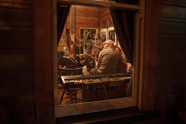 Tamara James; Looking through a window at Hum Salon at the Grafton intersection; Albi and the Wolves play to a small crowd.