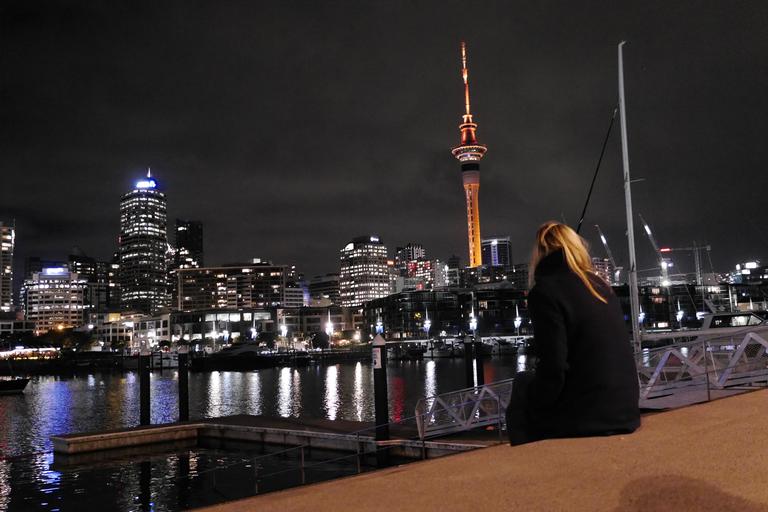 Timo Mueller;Silent Matariki Celebration;Having a moment of silence while looking at the Skytower, lit up in orange for Matariki Festival celebrating Maori New Year. The picture is also taken to capture the matching contrast between tower, hair and ground to create a connection.