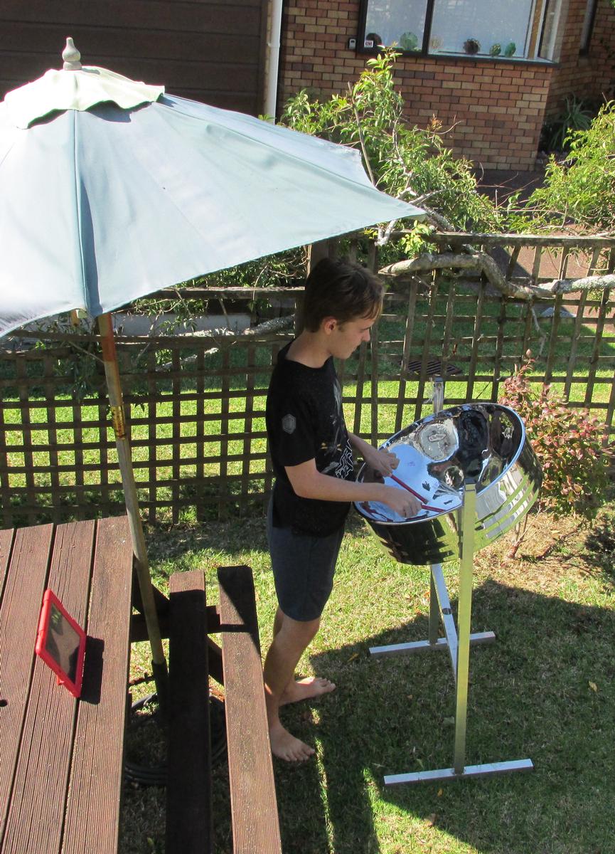 Angela Stanfield; Playing music for an elderly neigbour;When I phoned my elderly neigbour to check on her during lockdown, she said she hadn't heard my son playing his steelpan drum lately.  So I parked it outside for him to play for her.  She was happy.