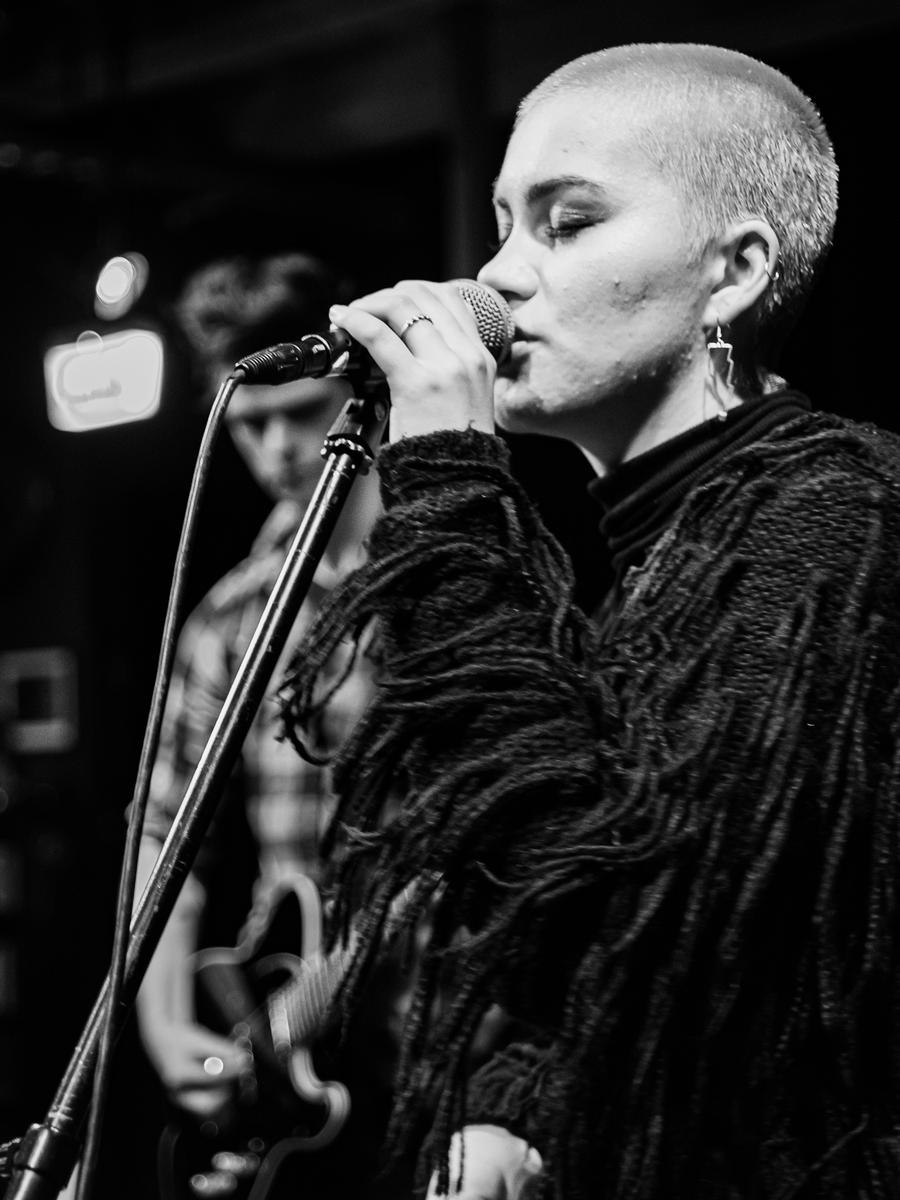 Patrick Rose; Black Swans Can Sing; Looking back in my album, “The Best of 2019” I saw this image I took of Mariah McKernan as a backup singer for an end of year exam performance at A Rolling Stone. The reason for the Title name is that it reminds me of Natalie Portman’s award winning role in “Black Swan”.