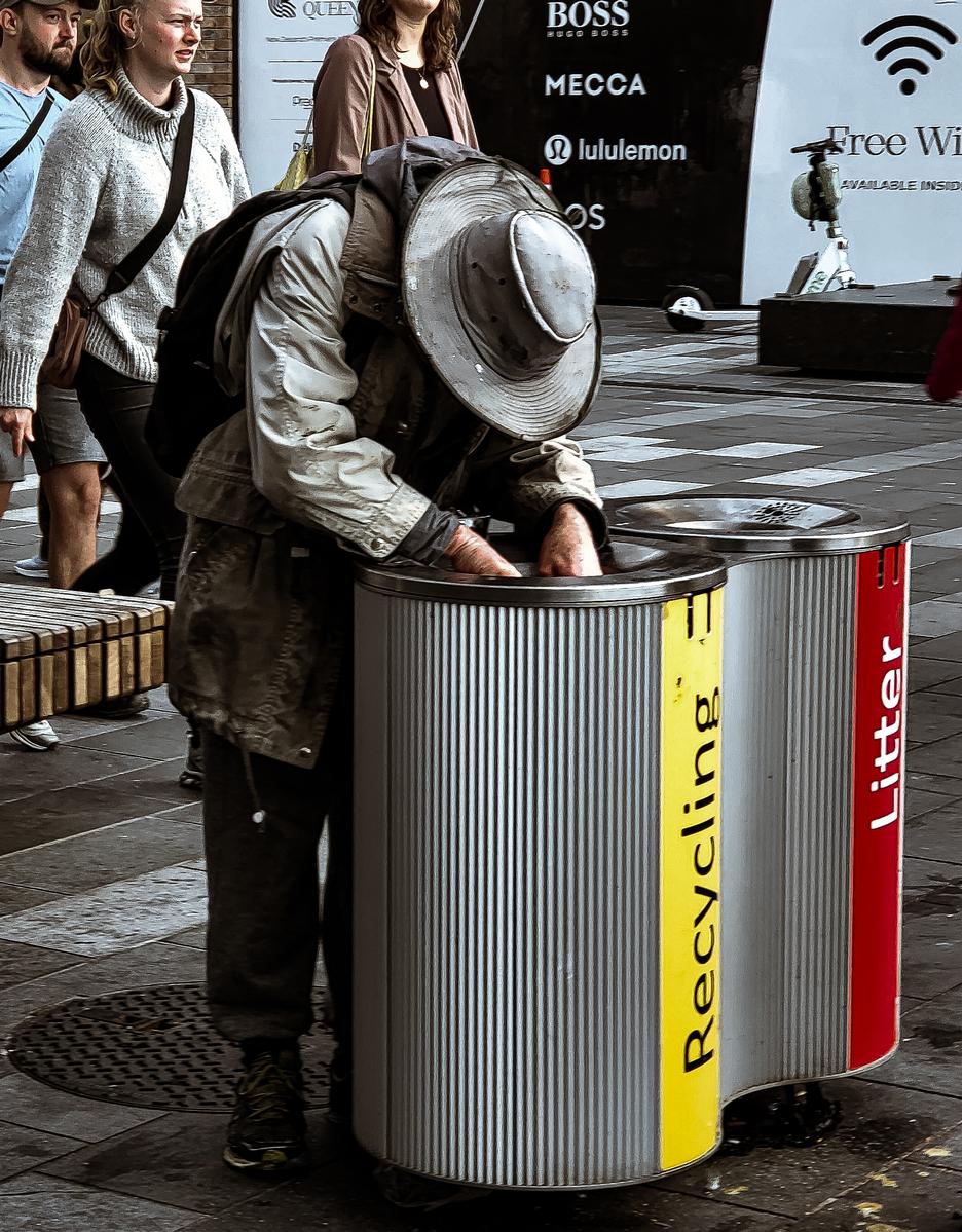 Anuke Rnanweera;A man searching for hope;A man going through a recycling bin hoping to find something he can use