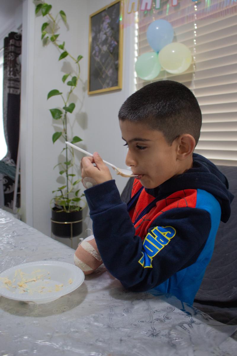 Arshpreet Kaur;Cake lover;A day before my cousins 6th birthday, he hurt his hand and spent the night at the doctors. He got home very late on his birthday but we were determined to have a party since he loves birthday cakes. While all the adults were busy talking, he ate on the sly and I managed to capture it.