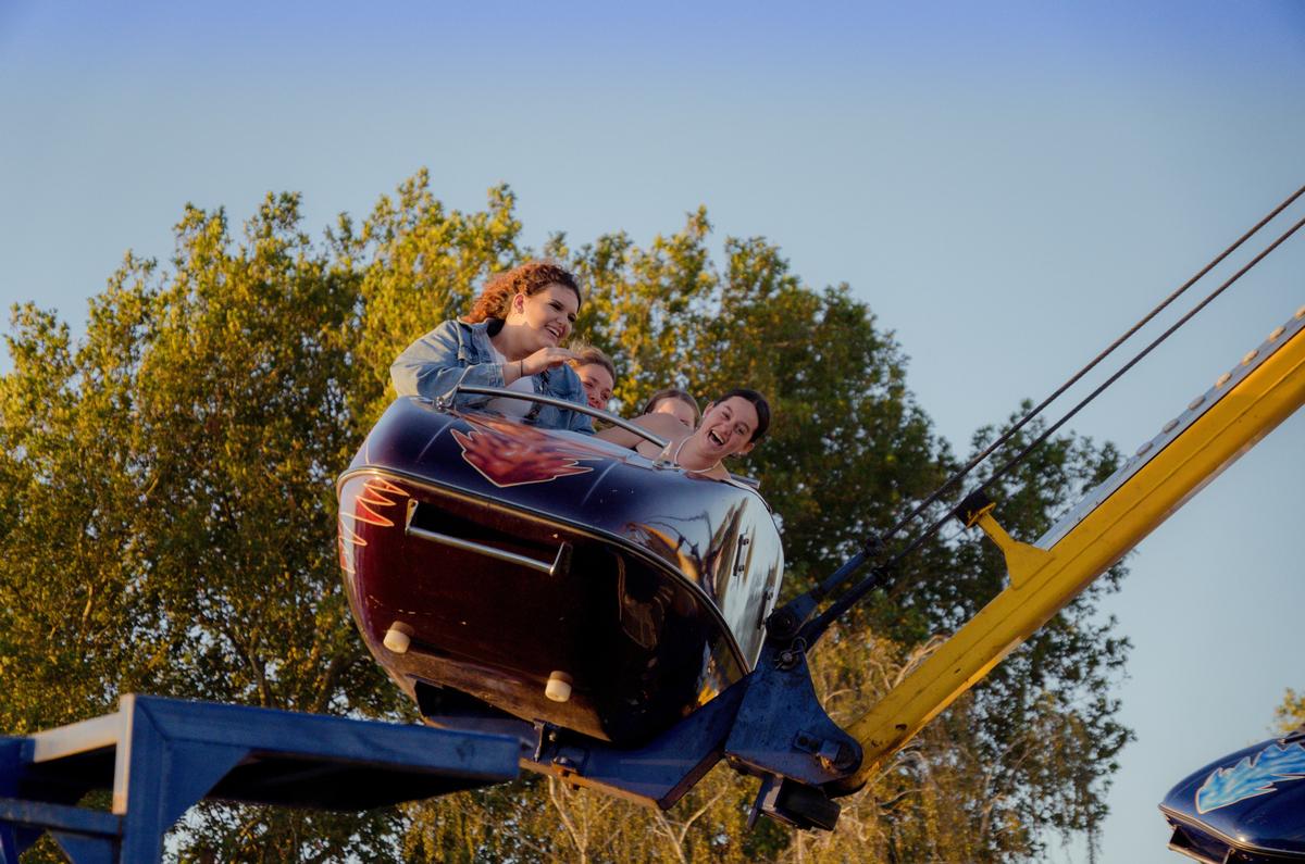 LEYAO LIU;Thrill Seekers;A lively photo of a group of people on a scream machine at the Hamilton hot balloon event. The photo shows their expressions of excitement and happiness, as they enjoy the adrenaline rush of the ride.