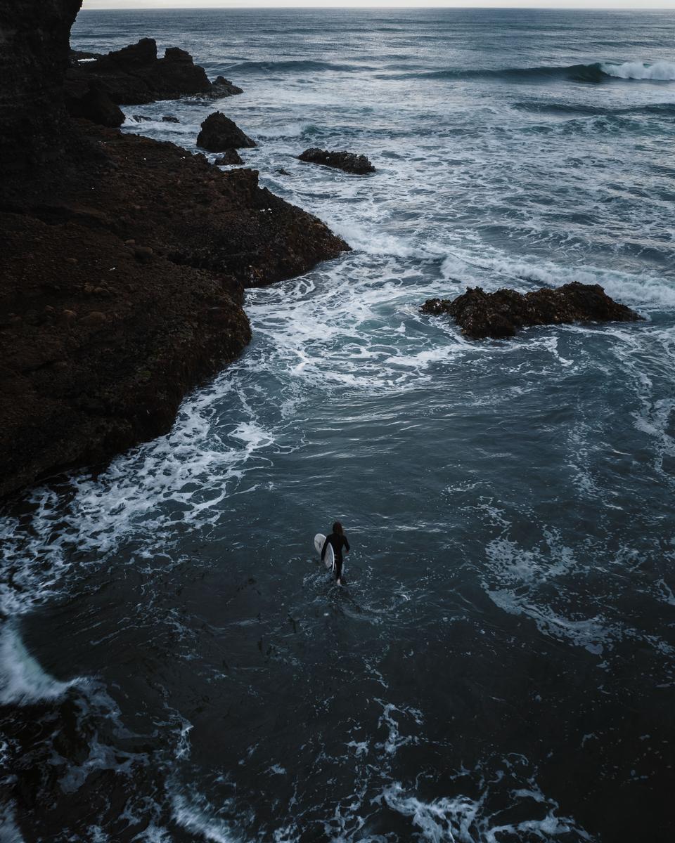 Tieshu Zhu;Embracing the Tempest;With unwavering determination, a lone surfer fearlessly ventures into the depths of the ocean, defying the mighty wind and crashing waves. The fusion of human and nature becomes evident as the surfer becomes one with the elements, embodying both strength and vulnerability. In this breathtaking image, the juxtaposition of the surfer's small figure against the vast expanse of the sea amplifies the sense of awe and admiration for those who bravely confront the untamed forces of nature. It serves as a powerful reminder of the indomitable spirit and the unyielding pursuit of passion in the face of challenges.