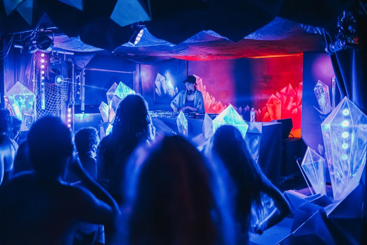 Mili Villamil;Hidden Reef;Shot from Shipwrecked Festival, the Hidden Reef stage lit up with glowing crystals and music by Aotearoa's drum & base artist Paige Julia.