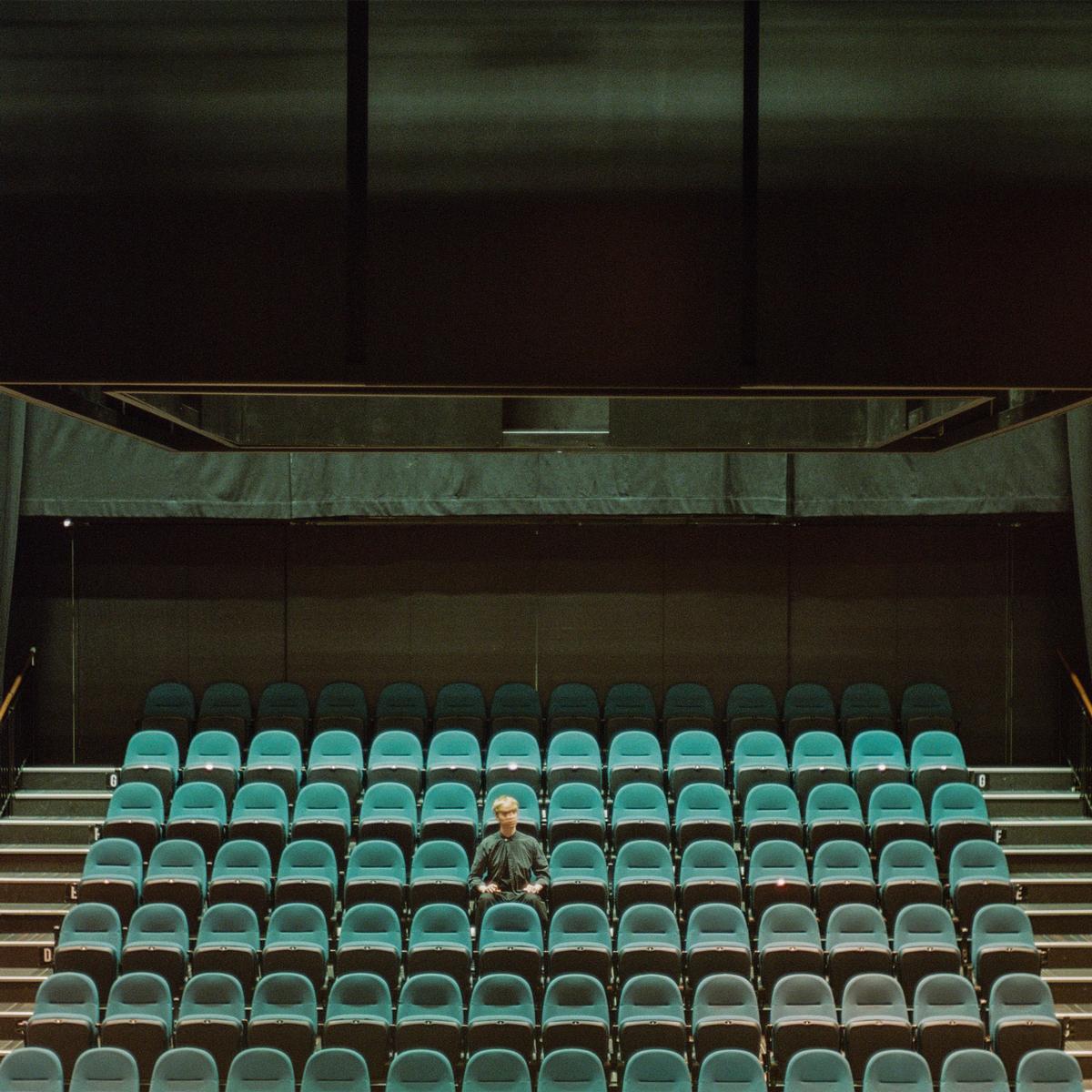 Felix Wang;sitting beside promotional material for an upcoming release by Tāmaki Makaurau indie artist Ben Chavasse. The first two photographs were taken inside a theatre in Tāmaki Makaurau, while the third was shot near University of Auckland, close to the music block where Ben studied. Ben described his upcoming song, “sitting beside,” as “what felt like a pivotal moment in my young life, and looking back on that time only to realise how inconsequential it was.