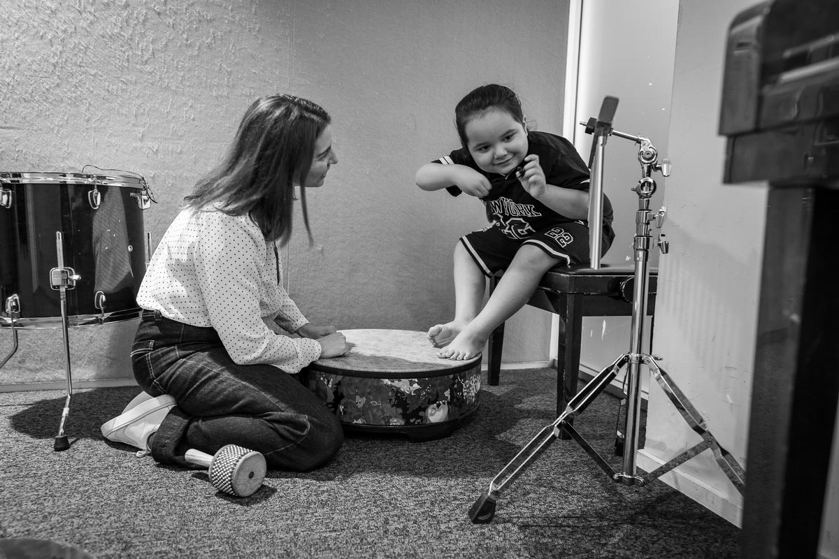Francesca Brugnoli; For Dean, connection doesn’t really happen through words. Dean during a music therapy session with his therapist Rachel Foxell at the Raukatauri Music Therapy Centre in Auckland. Originally produced for E Tangata, this documentary photo essay explores connection and healing through music therapy.