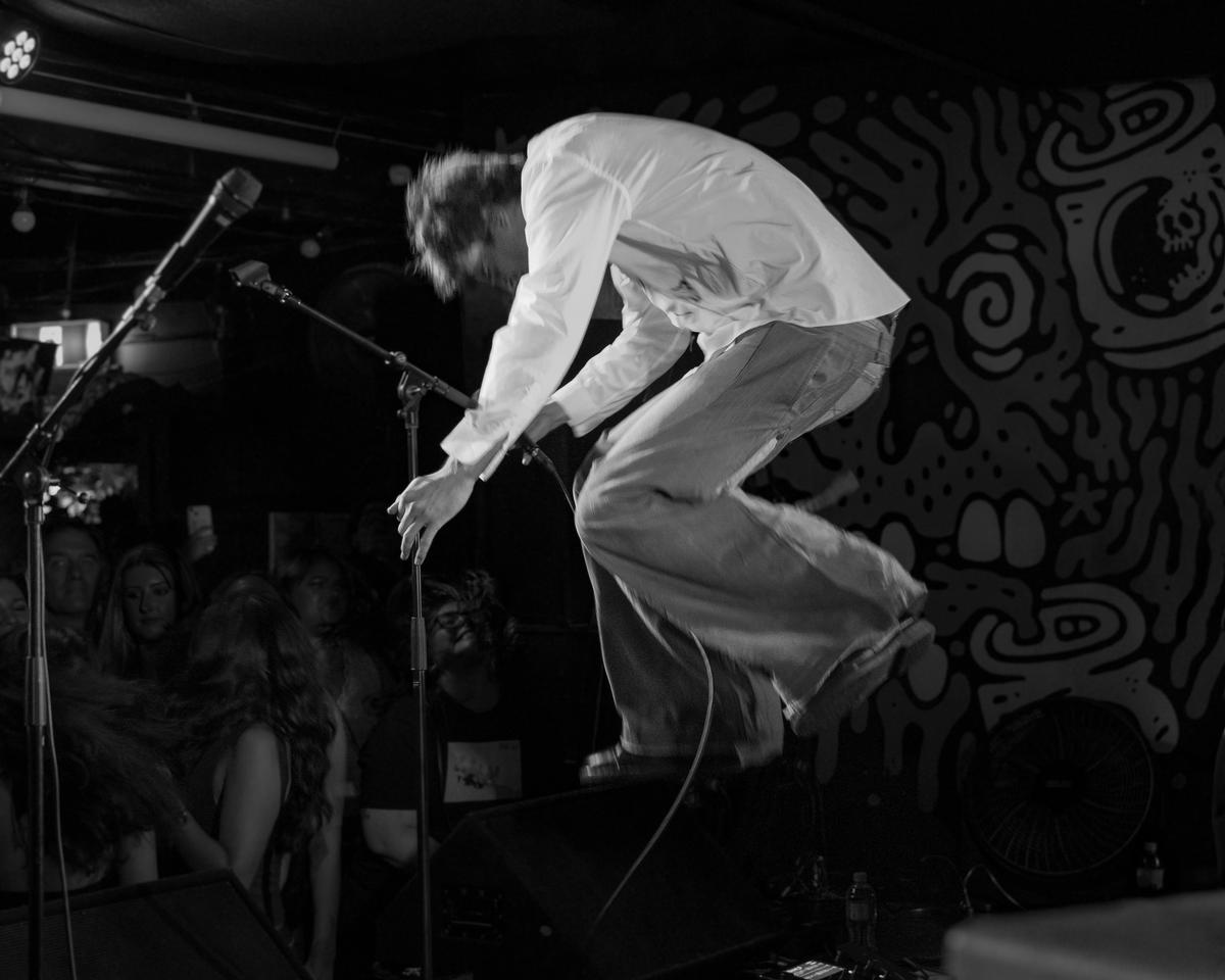 George Forbes; The Crouching Jump; Park Rd's tall Tom Chamberlain mid flight during the band's Farewell Show in Auckland