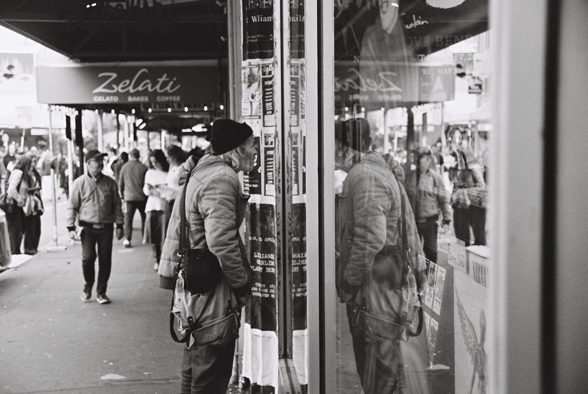 Liam Scrivener; Reflection; Man inspects the records in the window at Slow Boat, Wellington (2026)