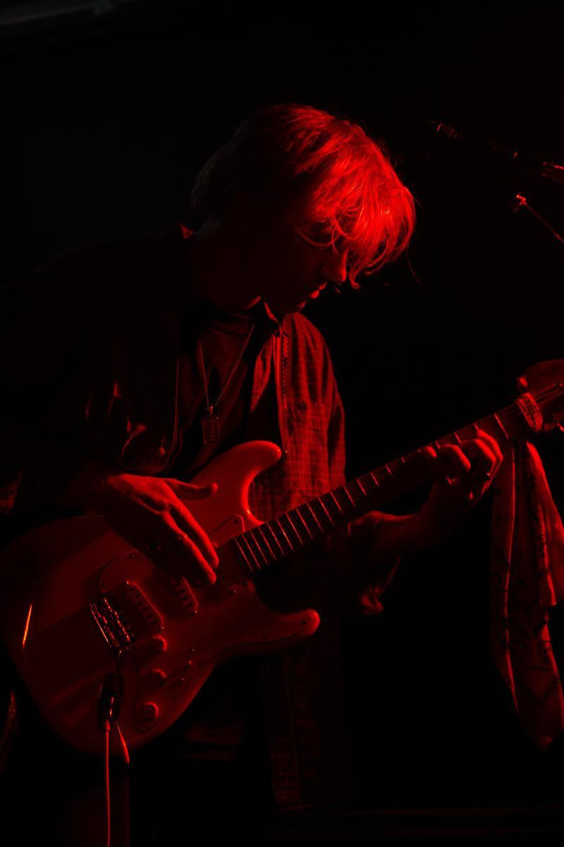 Georgia Fitzpatrick; Rory Seraphim; The darkness of Flux absorbes the bassist of Seraphim, hanging on to red illumination